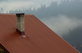 roof of a new home with ceramic chimney metal roof tiles gutters roof window